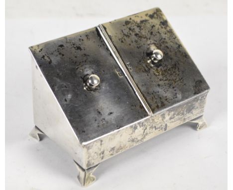 An Edward VII hallmarked silver trinket/visit card box with sloping twin lidded top and bun handles, on four bracket feet, De