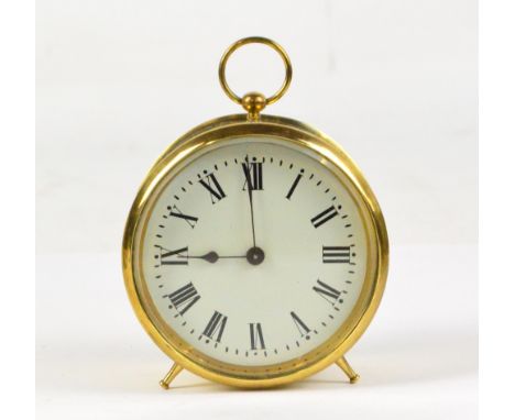 An early 20th century circular drum clock with ring loop handle and Roman numerals to the white enamel dial, diameter 9.8cm.