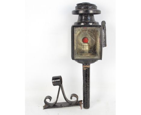 A late 19th century carriage lamp inscribed J. Cockshoot and Co, Manchester, with bracket. CONDITION REPORT: Breaks to both s