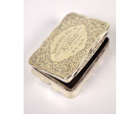 A Victorian hallmarked silver snuff box of shaped rectangular form, engraved with foliate scrolls to the base and hinged lid 