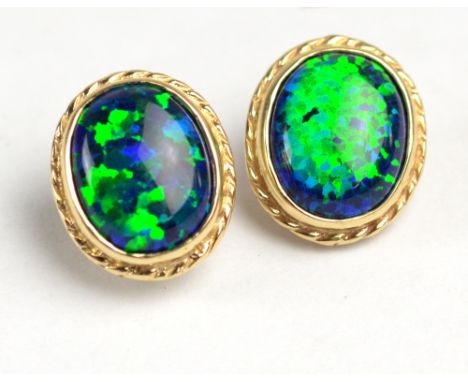 A pair of 9ct yellow gold and black opal oval ear studs with butterfly clasps, each approx 1.2cm.