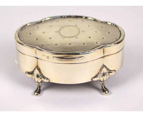 A George V hallmarked silver jewellery box of oval lobed form centred with a vacant circular cartouche to the linear decorate