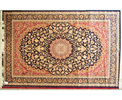 A blue ground Keshan carpet with large cental motif within a floral set border, 230 x 160cm