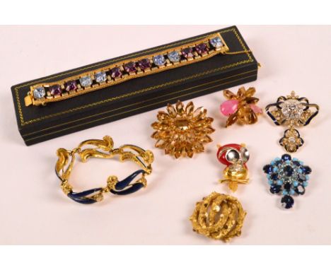 A group of costume brooches to include enamel detailed owl example, and two bracelets.