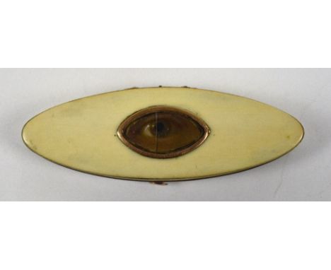 A 19th century ivory patch box of navette form, the hinged lid set with a later watercolour of an eye, enclosing a mirrored i