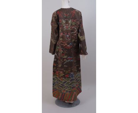 A 20TH CENTURY WOVEN CHINESE DRAGON ROBE. Woven silk with hidden brass button fastenings down the front, the robe is fully li