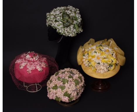 A 1960'S 'MISS DIOR' FLOWER HAT AND COLLECTION OF FLOWER HATS To include a Lily of the valley green and white flower hat labe