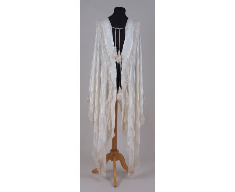 A 1920'S CREAM SILK CLOAK & SHAWL Heavy cream silk with fringed edges and tassel fastenings and a further cream silk shawl. (