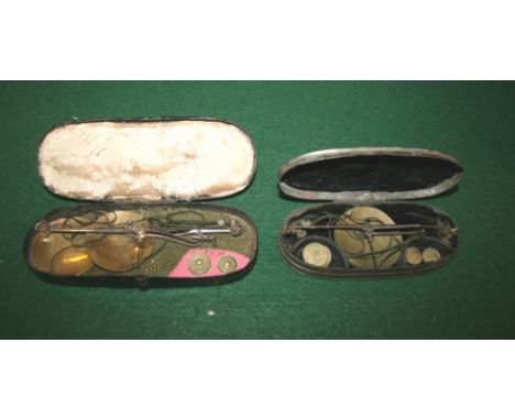 TWO SETS OF SCALES two small sets of scales and weights, both contained in metal tins. (2)