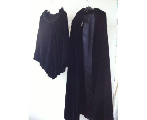 A LONG VELVET CLOAK & RUFFLE CAPE A heavy black velvet cloak with a silver tone fastening, labelled "Raymond of London". and 