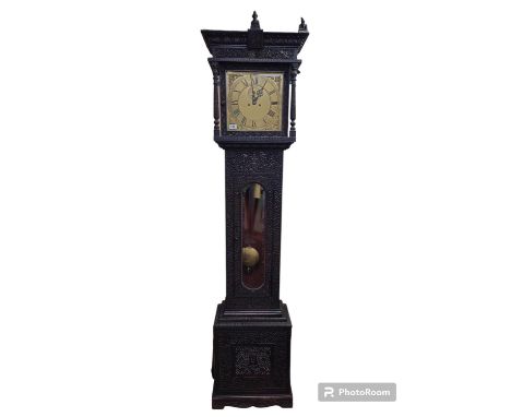 Anglo Indian carved Longcase clock with brass dial. Highly carved floral and figural carved with weights and pendulum. 227cm 