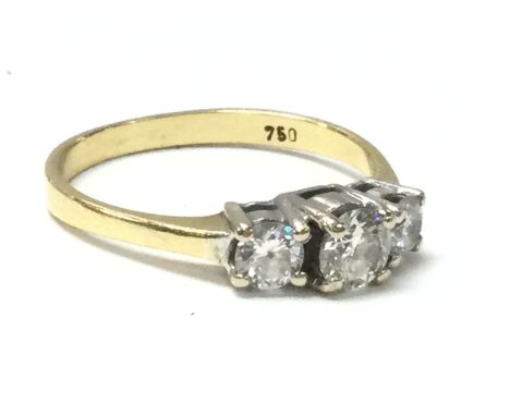 An 18ct gold ring set with three diamonds, size J/K. Overall weight 2.3G. Postage category A