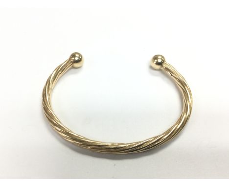 A 9ct gold torque bangle, approx 8.27g. Shipping category A.