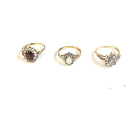 Three 9ct gold rings set with various gems including ruby and opal. Sizes N 1/2 M 1/2 and N. 6g total. Postage A