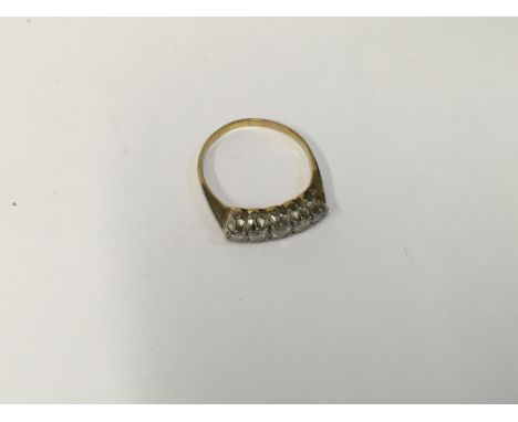 An unmarked gold ring set with a row of five diamonds. Approx size K, Approx weight 1.90 grams.