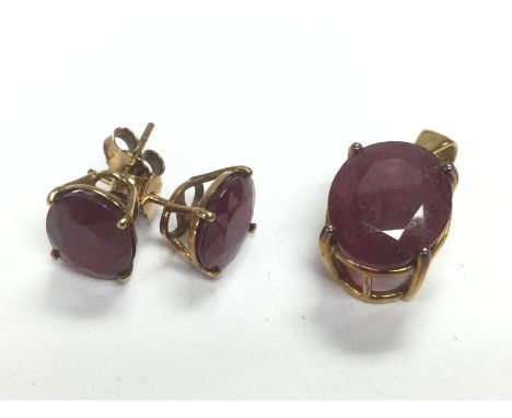 A pair of 9ct gold ruby earrings set with rubies together with a matching pendant, approx total weight 7.3g. Shipping categor