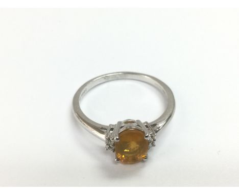 A 9ct white gold ring set with an oval cut fire opal flanked by white sapphires. Opal approx 1.00ct, sapphires approx 0.08c, 