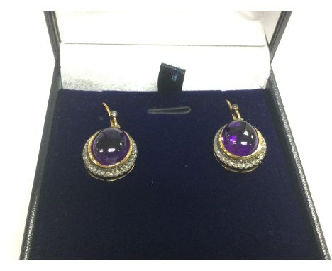 A pair of cabochon amethyst and diamond halo drop earrings in yellow metal. Amethysts approx 2.70ct, R/C diamonds 0.50ct. Shi