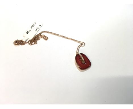 A 14ct gold chain and red enamel pendant, approx 3.33 grams.