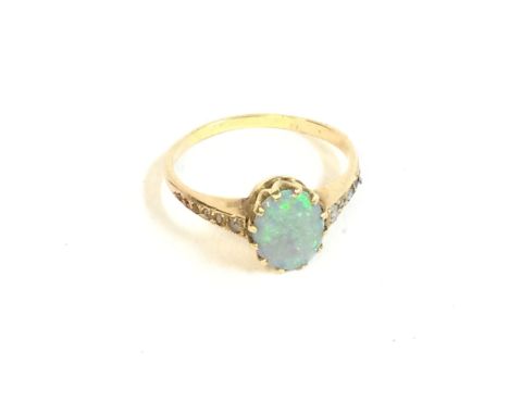 An 18ct opal ring set with diamonds to the shoulders. Ring size N and 2.60g. Postage A