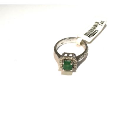 A 14ct white gold diamond and emerald ring. Approx 0.43 cts, approx weight 3.8 grams, ring size L.