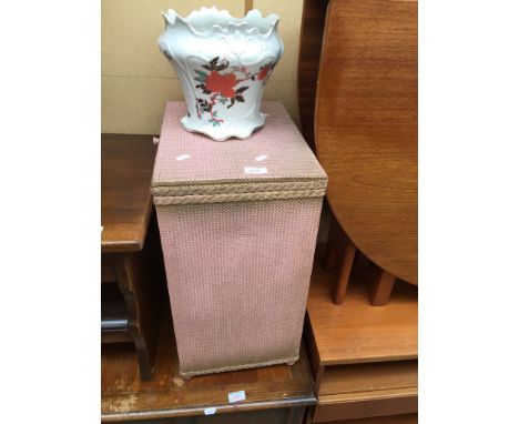 A PINK WOVEN LINEN BASKET AND A PLANTER
