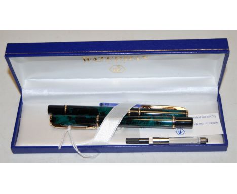 A Waterman's faux malachite and gilt banded cased fountain pen together with a matching ball pen, with refillls, boxed   Cond
