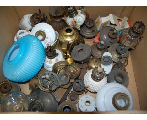 Two boxes of assorted oil lamp fonts, chimneys, burners etc 