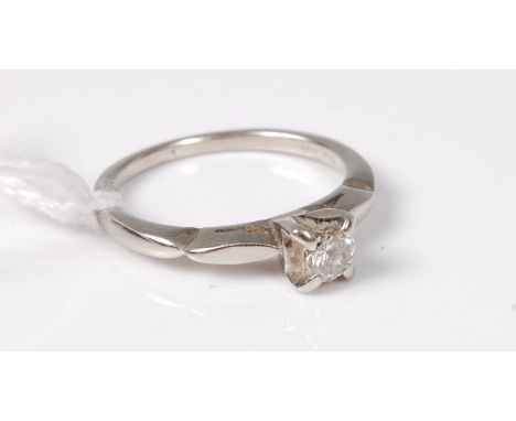 A single stone diamond ring, the round brilliant cut diamond, estimated approx. 0.23cts, claw set to shaped shoulders and pla