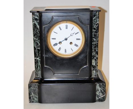 A late Victorian slate mantel clock having enamelled dial with Roman numerals and eight day movement striking on a bell, heig