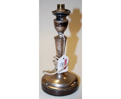 A silver candlestick, loaded and converted to table lamp