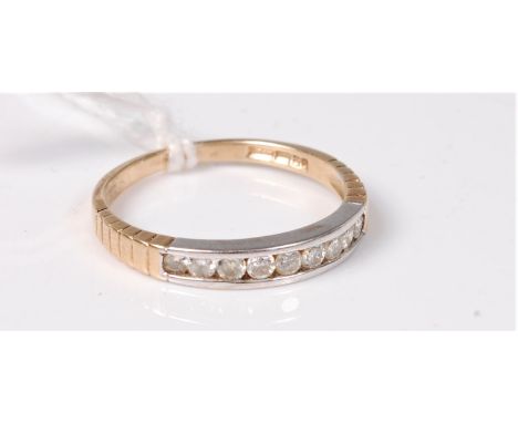 A 9ct half hoop diamond ring, the small round brilliant cut diamonds, total estimated approx. 0.1cts, channel set in white me