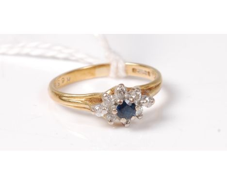 An 18ct sapphire and diamond cluster ring, total estimated weight of diamonds approx. 0.08cts, hallmarked Sheffield 1980, siz