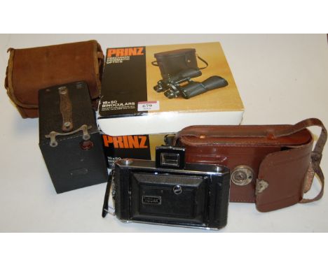 A pair of Prinz precision prismatic optics 16x50 binoculars, boxed, together  with a Box Brownie camera, and a Kodak camera (