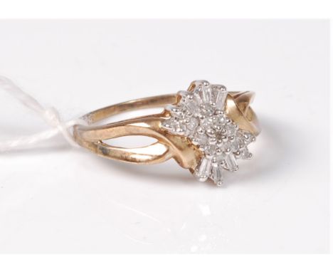 A 9ct diamond cluster ring, the asymetrical diamond cluster comprising of round brilliant and bagette cut diamonds, total est