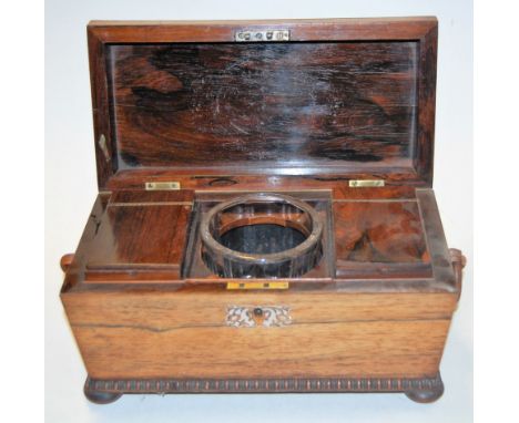 A Victorian rosewood and mother of pearl inlaid tea caddy of sarcophagus form, the hinged lid opening to reveal central mixin