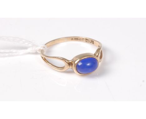 A 9ct blue hardstone ring, the oval blue cabochon in collet mount, open teardrop shaped shoulders and plain band, hallmarked 