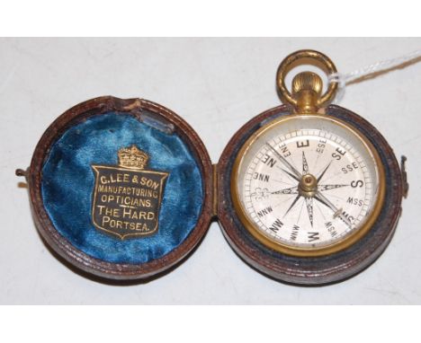 A late Victorian gilt metal cased pocket compass, having silvered dial, in fitted leather case bearing label for 'G Lee & Son