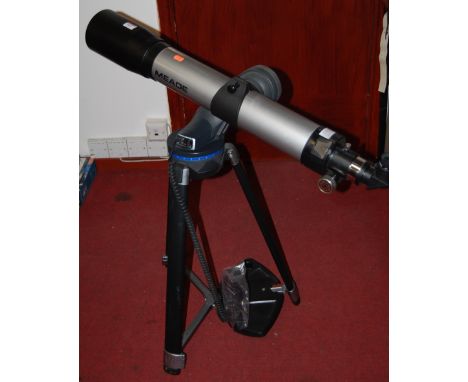 A modern Mead DS2000 series Reflecting and Refracting telescope on tripod base with computer control with various spare lense