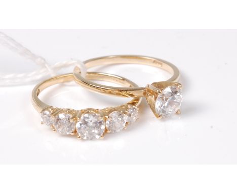 Two 14ct CZ rings, a single stone CZ ring and a graduated five stone CZ ring, both set in 14ct gold, both size Q, (4.4g)