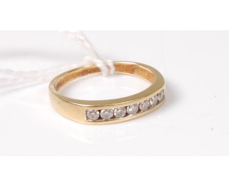 An 18ct half hoop diamond ring, the small round brilliant cut diamonds, total estimated approx. 0.25cts, channel set to a pla