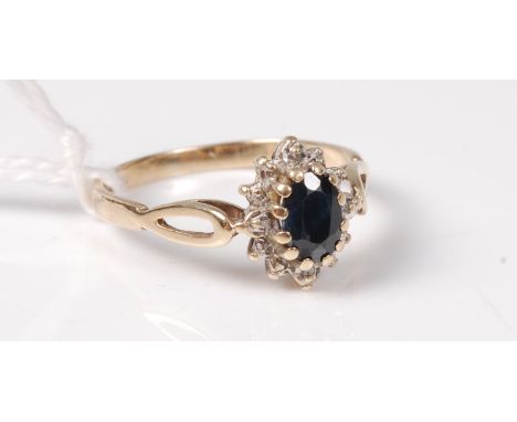 A ladies 9ct yellow gold, sapphire and diamond set flower head ring, size M