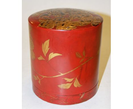 A Japanese red lacquered tea caddy, of cylindrical form, relief decorated with a dragon and heightened in gilt, with further 