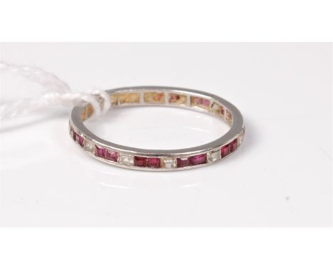 A ruby and diamond eternity ring, each square diamond alternating between two square rubies, all channel set in unmarked whit