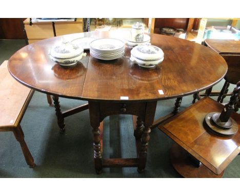 A 19th century design oak gate-leg table, with single cutlery drawer