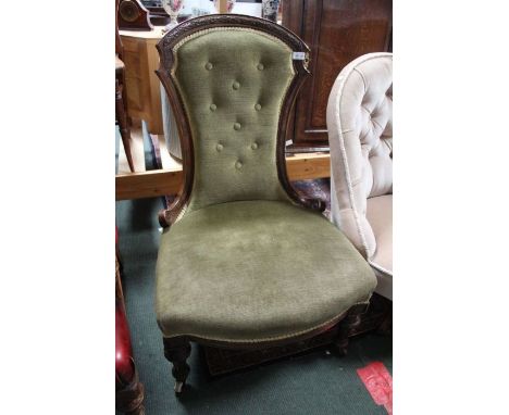 A late Victorian nursing chair, green upholstered with button back.