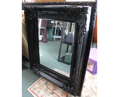 A large Black fancy framed mirror.