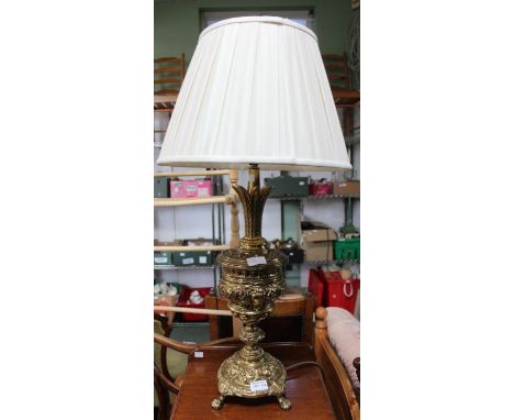 A decorative brass lamp with shade.