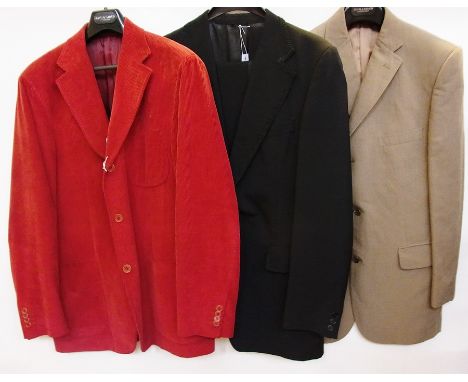 A rust coloured gentleman's corduroy jacket, a black gentleman's evening suit, the lapel trimmed with braid, single button fa