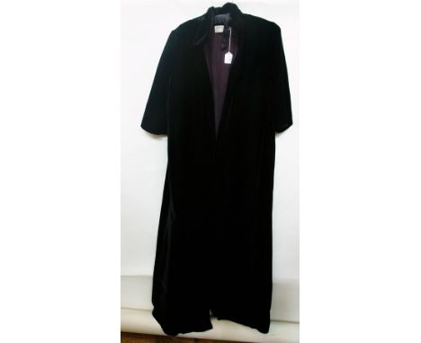 An Aquascutum black velvet opera cape with black faux jet buttons and a buckle tie, a Jean Allen black velvet evening coat, f